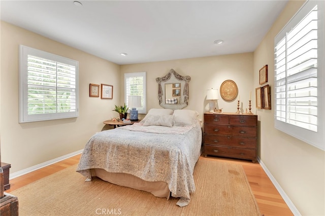 bedroom with baseboards and wood finished floors
