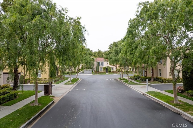 view of street featuring sidewalks, curbs, and a residential view