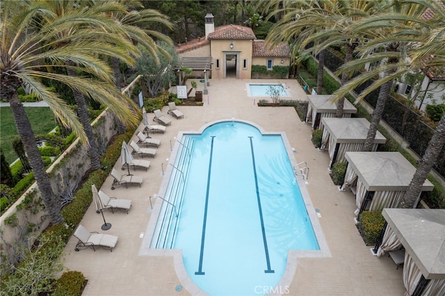 pool with fence and a patio