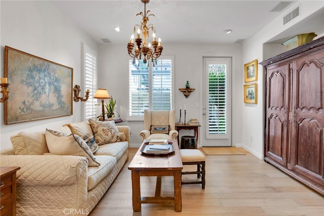 living room featuring recessed lighting, an inviting chandelier, baseboards, visible vents, and light wood-style flooring