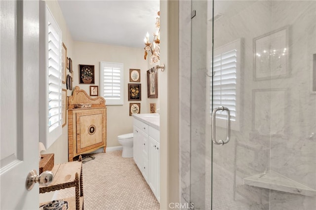 bathroom with toilet, vanity, a stall shower, and tile patterned flooring