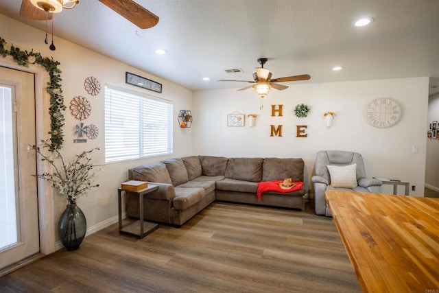 living room featuring ceiling fan, wood finished floors, visible vents, and recessed lighting