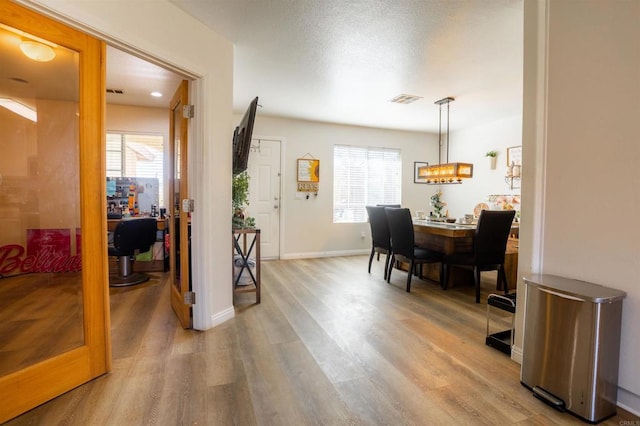 office space featuring light wood-style flooring and visible vents