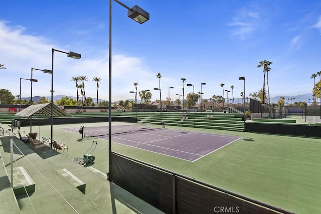 view of sport court featuring fence