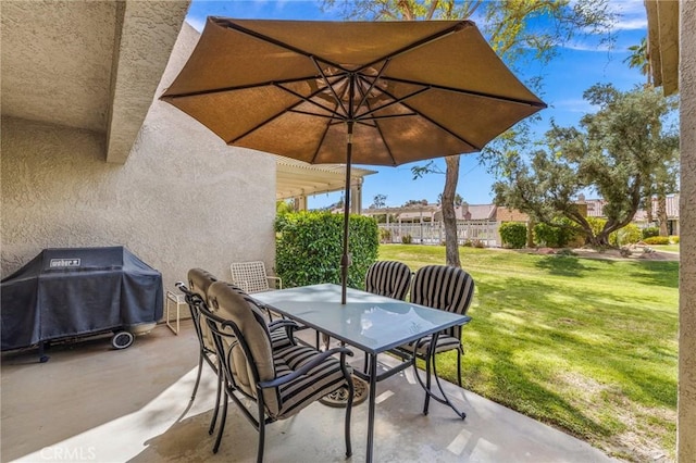 view of patio / terrace with outdoor dining area, area for grilling, and fence