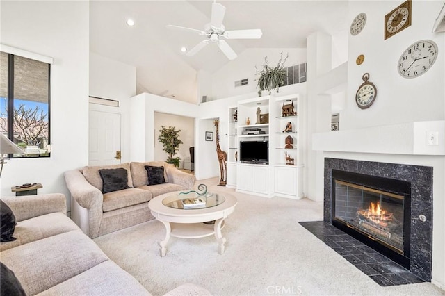 carpeted living area featuring high vaulted ceiling, visible vents, a premium fireplace, ceiling fan, and built in features
