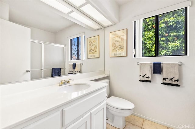 bathroom featuring toilet, a stall shower, tile patterned flooring, and vanity