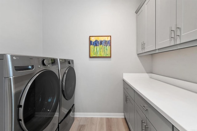 1518 Pepperwood Way, Oceanside, CA 92056 - washroom with independent washer and dryer, cabinet space, light wood-style flooring, and baseboards
