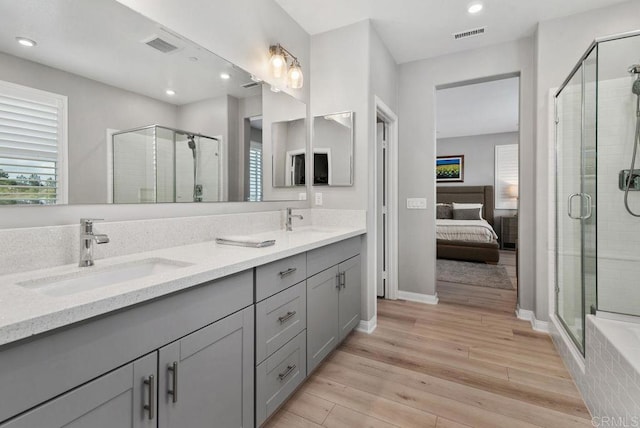 1518 Pepperwood Way, Oceanside, CA 92056 - ensuite bathroom with double vanity, a shower stall, wood finished floors, recessed lighting, and baseboards