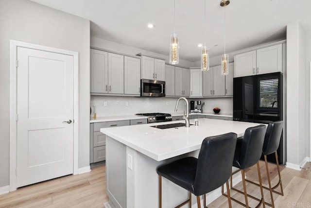 1518 Pepperwood Way, Oceanside, CA 92056 - kitchen featuring appliances with stainless steel finishes, light wood-style flooring, gray cabinets, backsplash, and recessed lighting