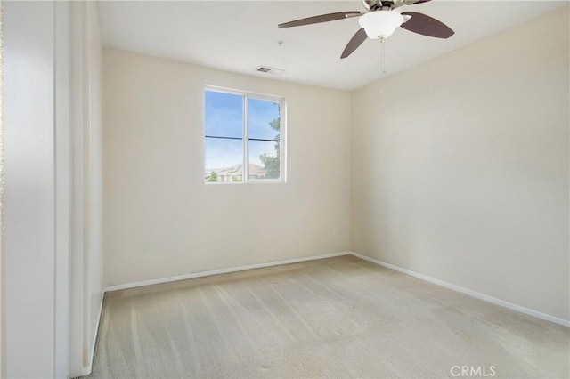 unfurnished room featuring light colored carpet, baseboards, and a ceiling fan