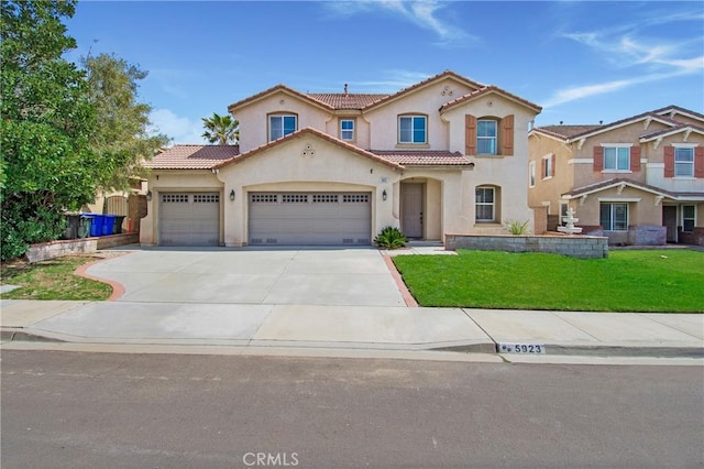 mediterranean / spanish home featuring concrete driveway, stucco siding, a front yard, a garage, and a tiled roof