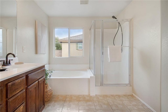 full bathroom featuring vanity, tile patterned floors, a shower stall, visible vents, and a garden tub