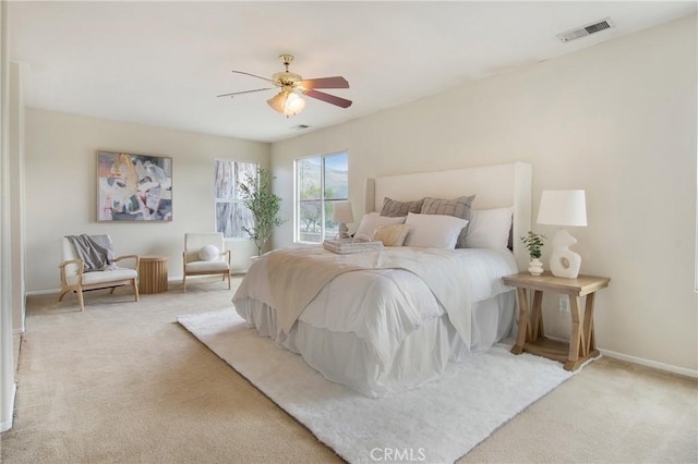 bedroom featuring carpet flooring, visible vents, baseboards, and ceiling fan