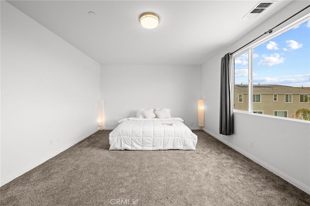 unfurnished bedroom with visible vents, baseboards, and carpet floors