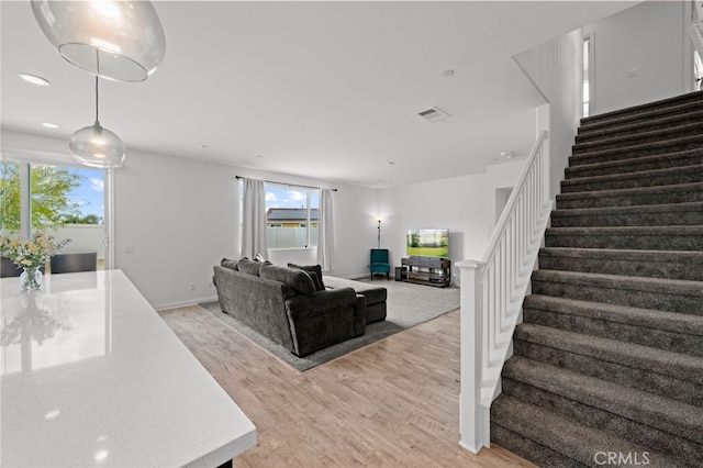 26382 Bramble Wood Cir, Menifee, CA 92584 - living room with stairs, light wood-type flooring, healthy amount of natural light, and recessed lighting