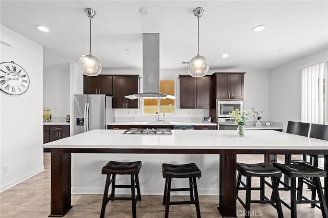 26382 Bramble Wood Cir, Menifee, CA 92584 - kitchen featuring stainless steel appliances, island range hood, light countertops, dark brown cabinets, and recessed lighting