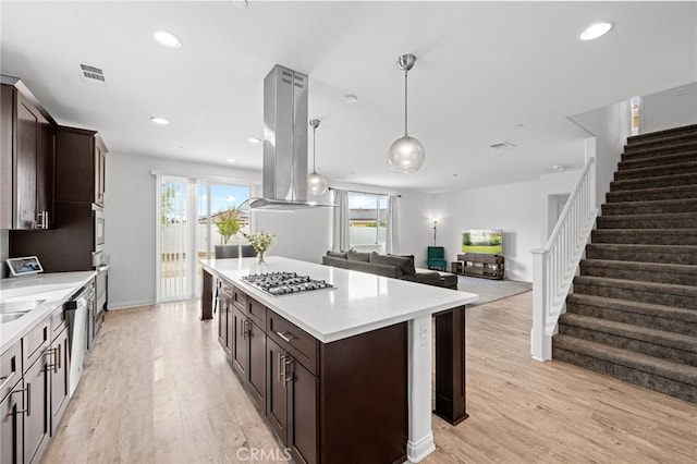 26382 Bramble Wood Cir, Menifee, CA 92584 - kitchen with stainless steel gas cooktop, dark brown cabinets, light wood-style flooring, and recessed lighting