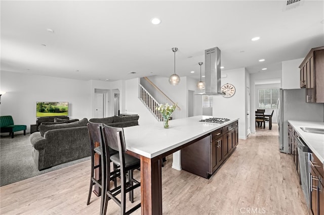 26382 Bramble Wood Cir, Menifee, CA 92584 - kitchen featuring island range hood, dark brown cabinetry, light countertops, light wood finished floors, and recessed lighting