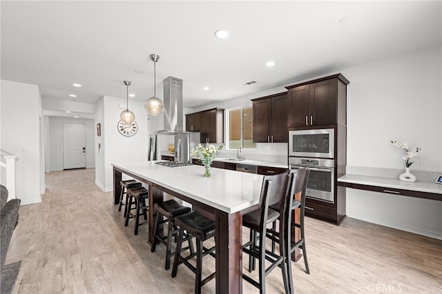 dining room with recessed lighting, light wood-style flooring, baseboards, and visible vents