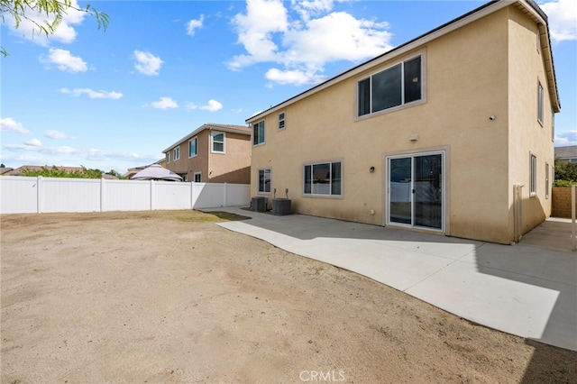 back of property featuring a patio, stucco siding, and a fenced backyard