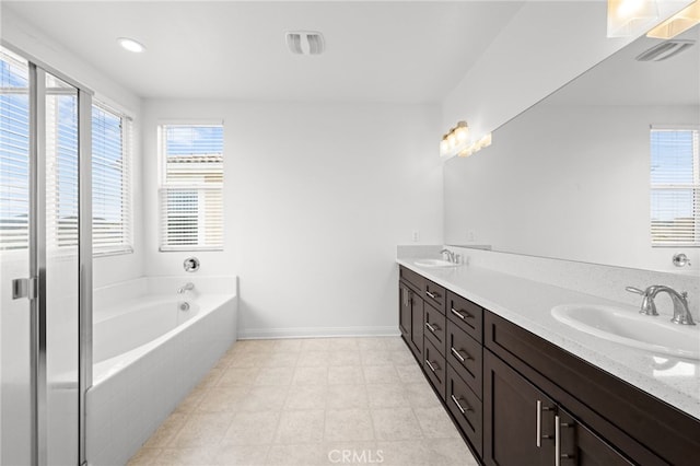 26382 Bramble Wood Cir, Menifee, CA 92584 - full bath with a garden tub, plenty of natural light, and double vanity