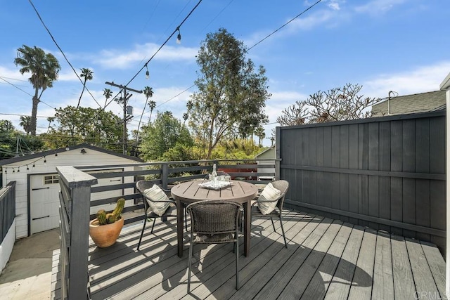 wooden deck featuring outdoor dining area
