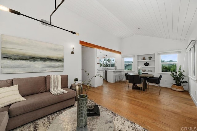 living area featuring light wood-style flooring, wood ceiling, high vaulted ceiling, and baseboards