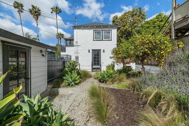 back of house featuring fence