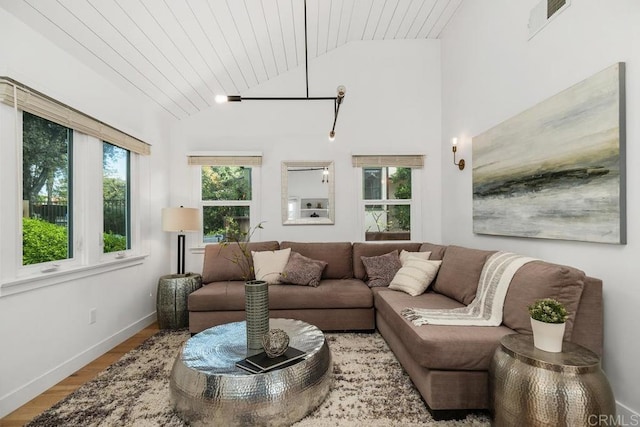 living area featuring vaulted ceiling, baseboards, wood ceiling, visible vents, and wood finished floors