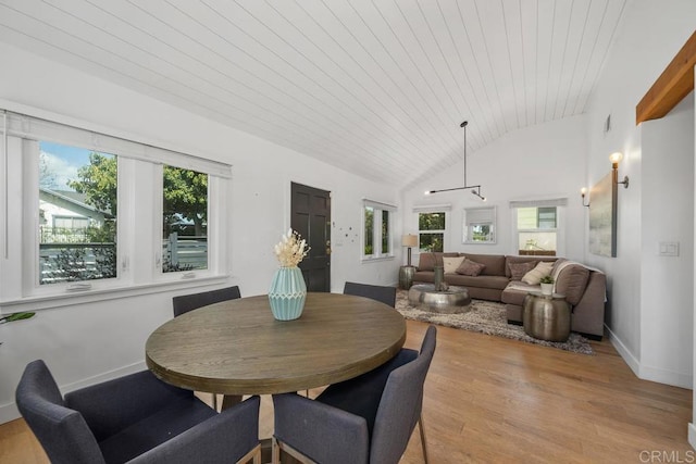 dining room featuring baseboards, light wood-type flooring, high vaulted ceiling, and wooden ceiling