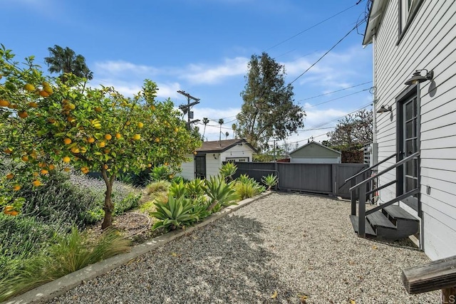 view of yard with entry steps and fence