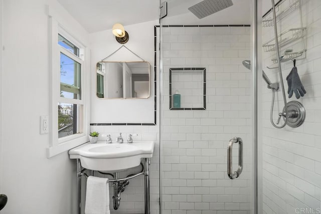 bathroom with a shower stall and a sink