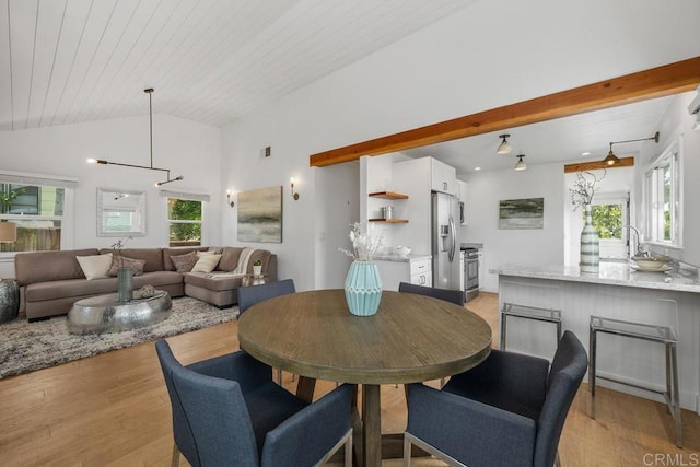 dining room with lofted ceiling with beams, visible vents, light wood-style flooring, and wood ceiling