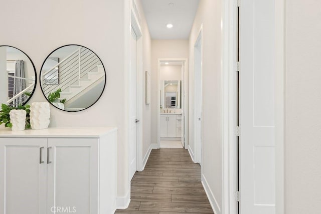 corridor featuring wood finished floors and baseboards