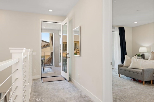 hallway featuring light carpet, baseboards, and recessed lighting