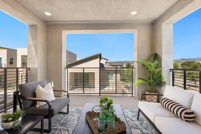balcony featuring a mountain view and an outdoor hangout area