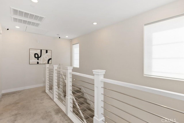 hall with visible vents, recessed lighting, carpet flooring, an upstairs landing, and baseboards