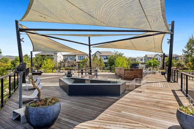 deck with a residential view and an outdoor fire pit