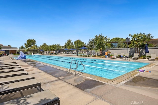 community pool featuring a patio and fence