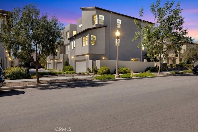 view of front of home with an attached garage and stucco siding