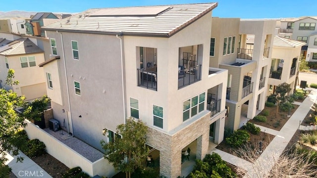 view of property featuring a residential view and central AC unit