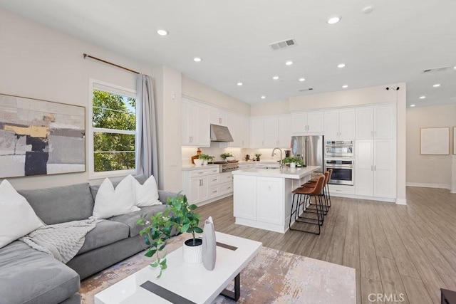 108 Shear, Irvine, CA 92618 - living room with light wood-type flooring, recessed lighting, and baseboards