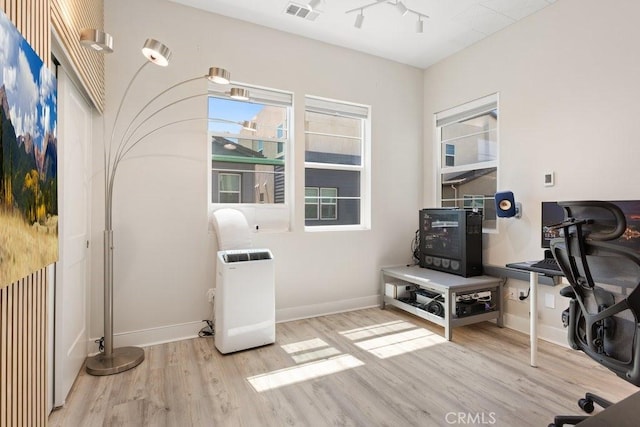 interior space with visible vents, baseboards, and wood finished floors