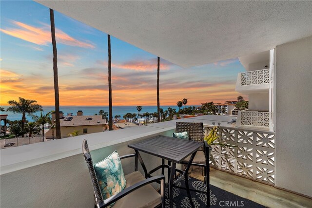balcony at dusk with a water view