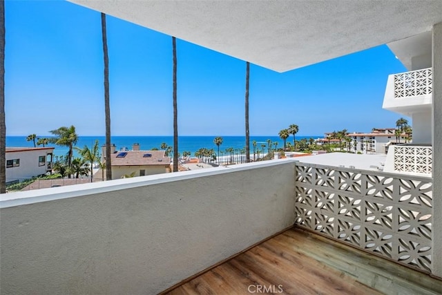 balcony featuring a water view