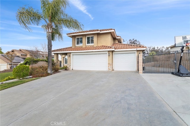 6816 Ridgeside Dr, Riverside, CA 92506 - view of front of home with stucco siding, concrete driveway, fence, a tile roof, and stone siding