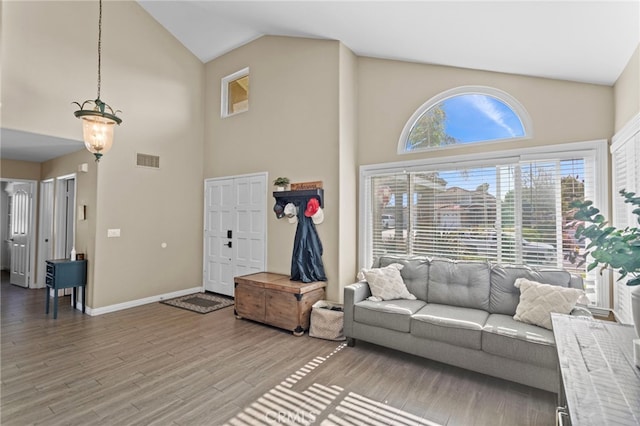 6816 Ridgeside Dr, Riverside, CA 92506 - living room with high vaulted ceiling, light wood-type flooring, and baseboards