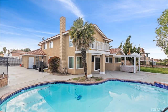 6816 Ridgeside Dr, Riverside, CA 92506 - rear view of house with a balcony, stucco siding, a patio area, a tile roof, and fence