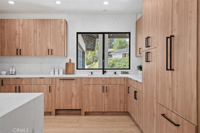 2037 Rayshire St, Thousand Oaks, CA 91362 - kitchen with a sink, light countertops, light brown cabinetry, light wood-type flooring, and recessed lighting